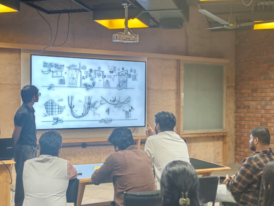 Students presenting a design on screen